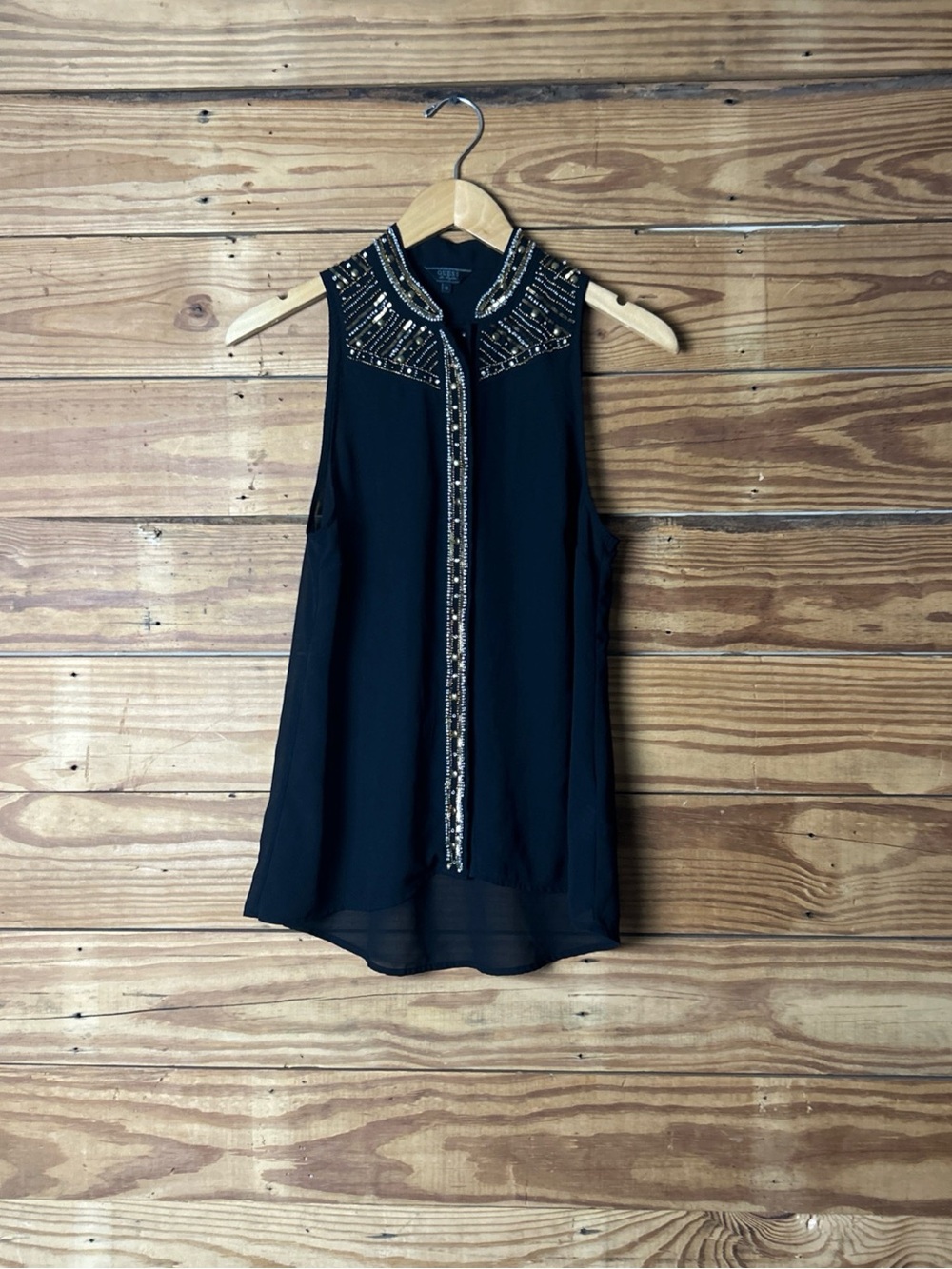Guess sheer black button top . Sleeveless embroidered with silver and gold .